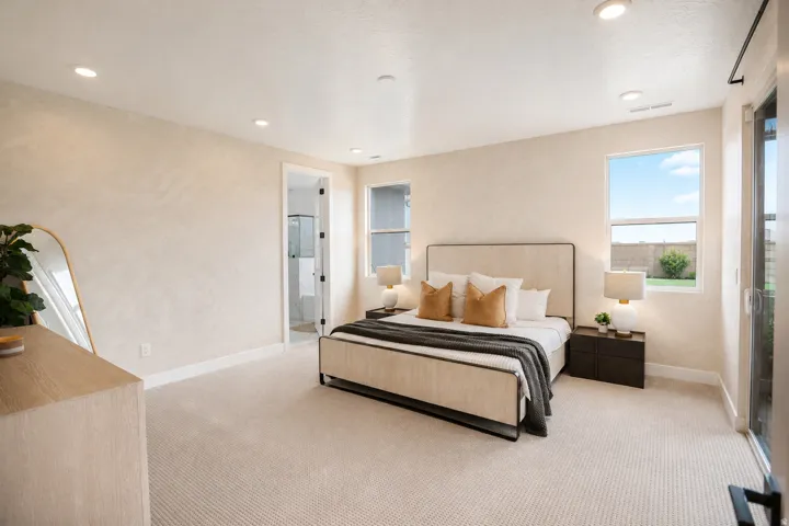 Recessed lighting, wall-to-wall carpeting, and a glass-enclosed shower