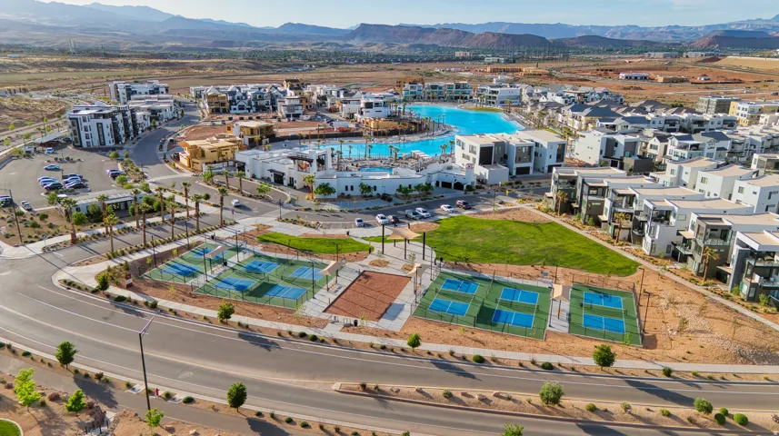 Community featuring a large water amenity, multiple sports courts, and contemporary residential structures