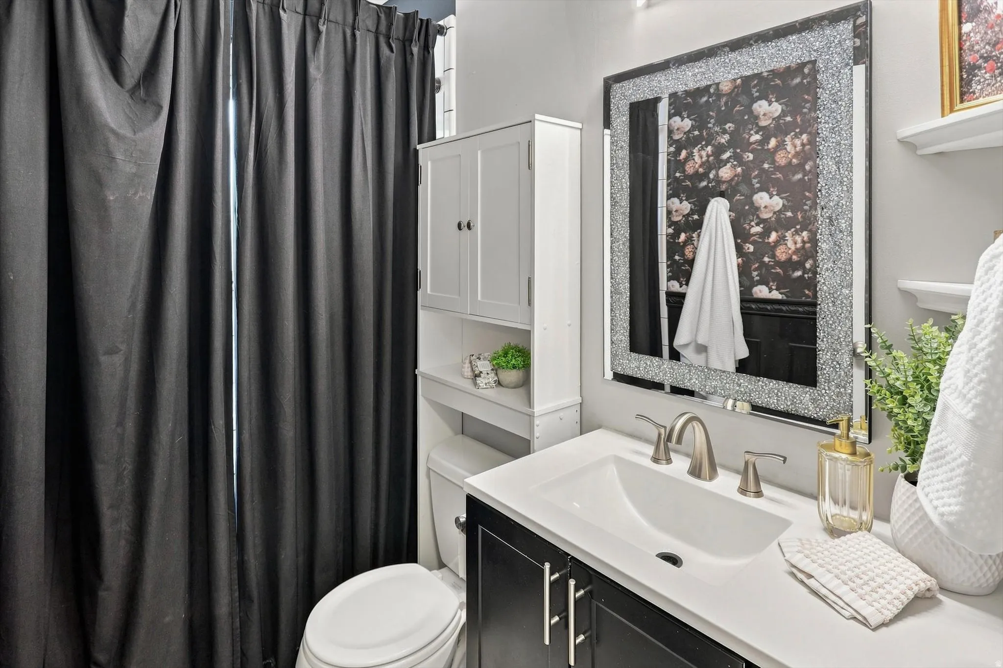 Vanity with white countertop, undermount sink, and brushed nickel faucet