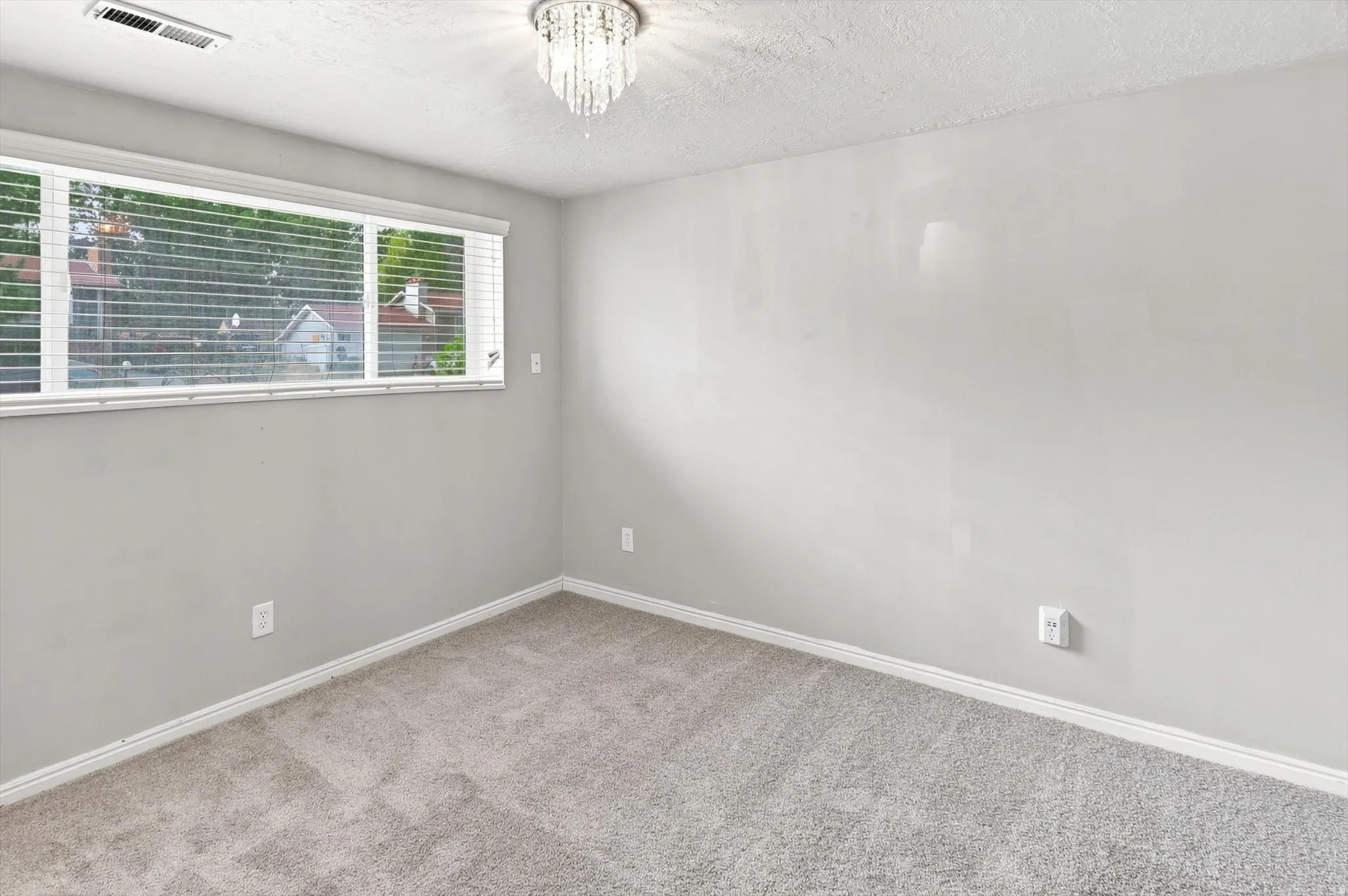 Neutral wall color complemented by light-toned carpeting