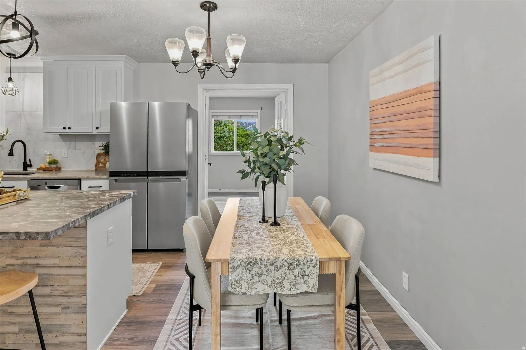Open-concept kitchen and dining area featuring light wood-finish flooring