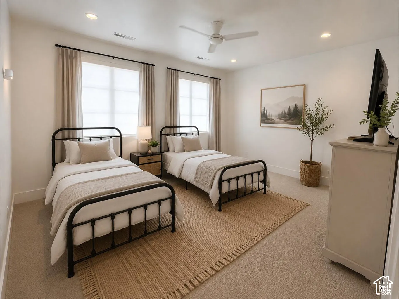 Spacious room featuring two large windows, recessed ceiling lighting, a ceiling fan, and light-toned carpeting