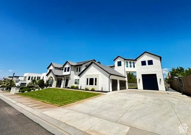 Contemporary white stucco exterior with dark trim and a gabled roofline