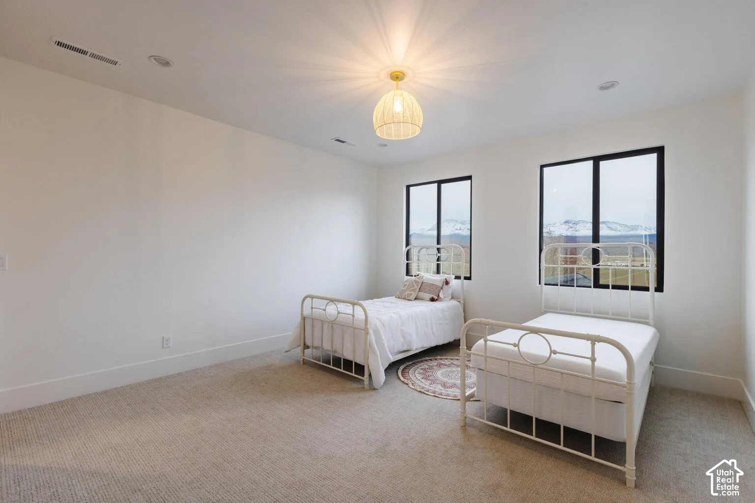 Spacious room featuring neutral carpeting and white walls