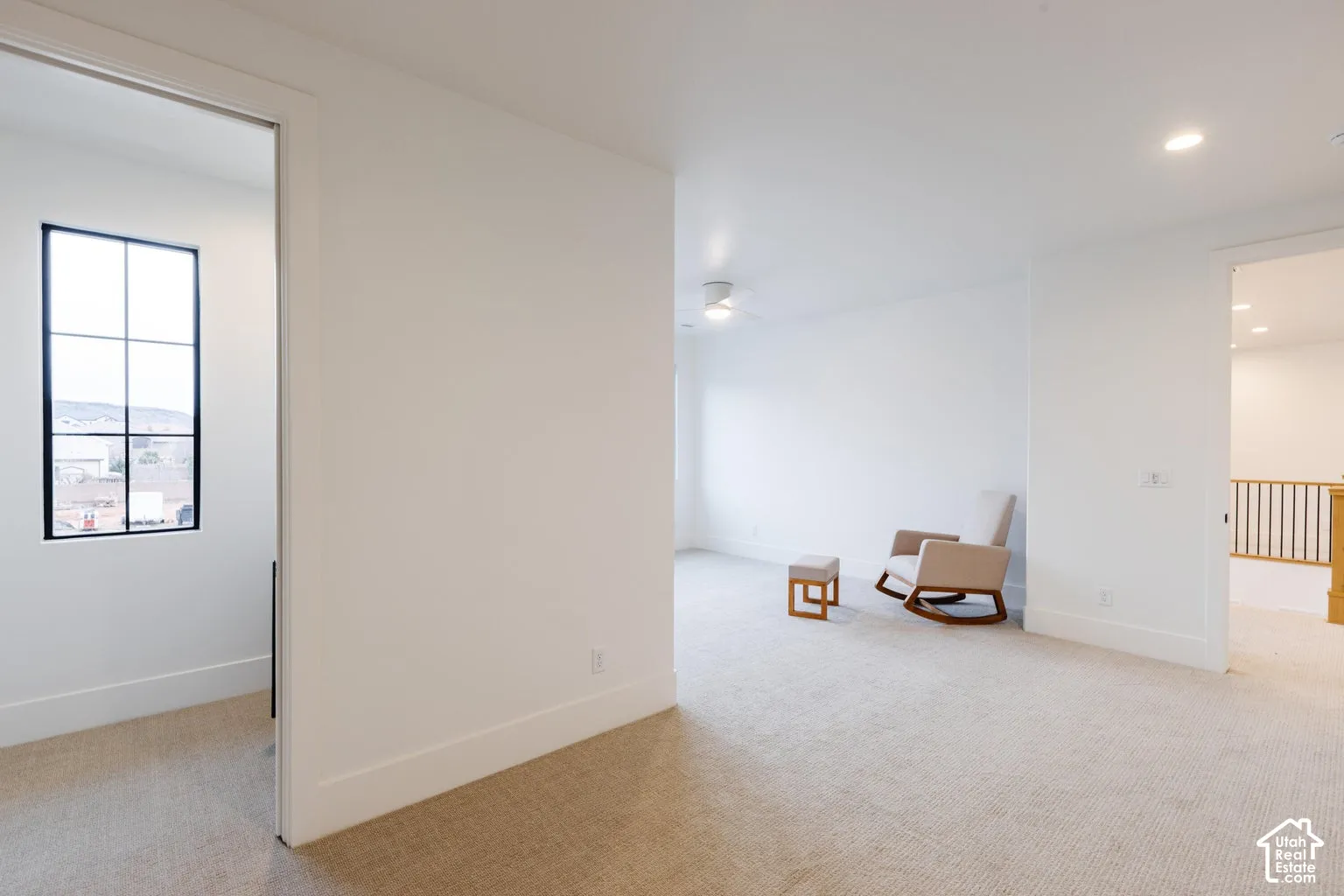 Carpeted room featuring white walls, recessed lighting, and a ceiling fan