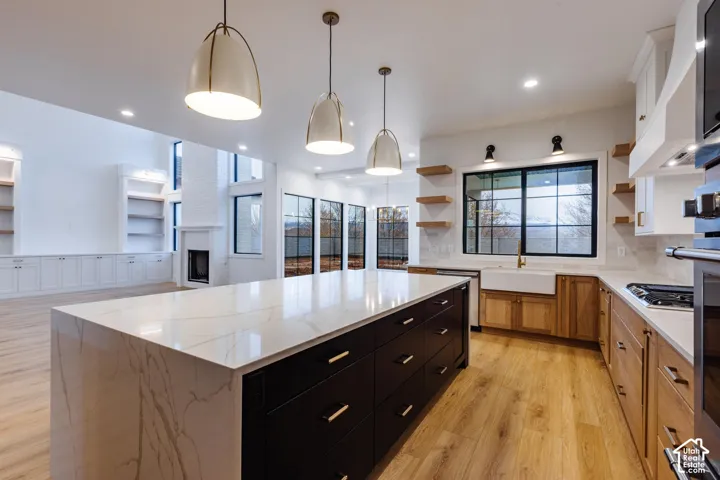 Expansive kitchen island featuring a waterfall countertop