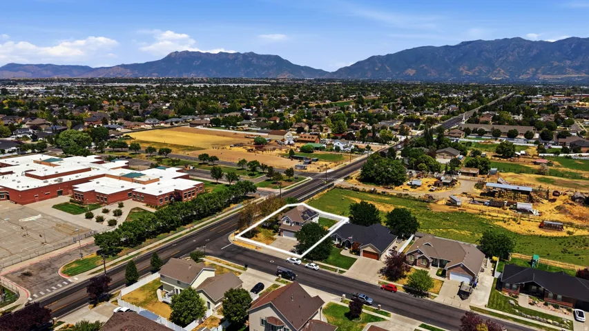 Residential property on a corner lot, featuring a fenced backyard and an attached garage