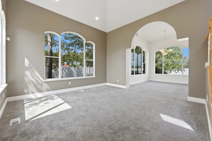 Spacious interior featuring vaulted ceilings and arched doorways