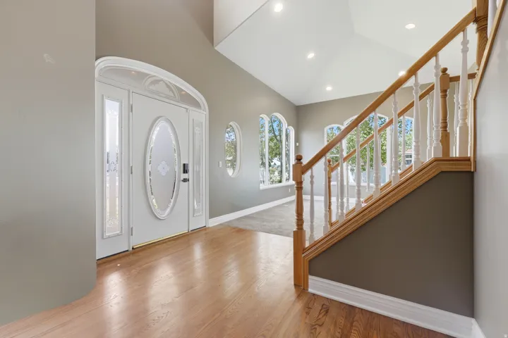 Grand entry foyer featuring hardwood flooring
