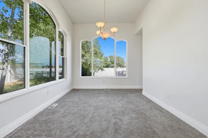 Bright interior space featuring a large arched window with white trim