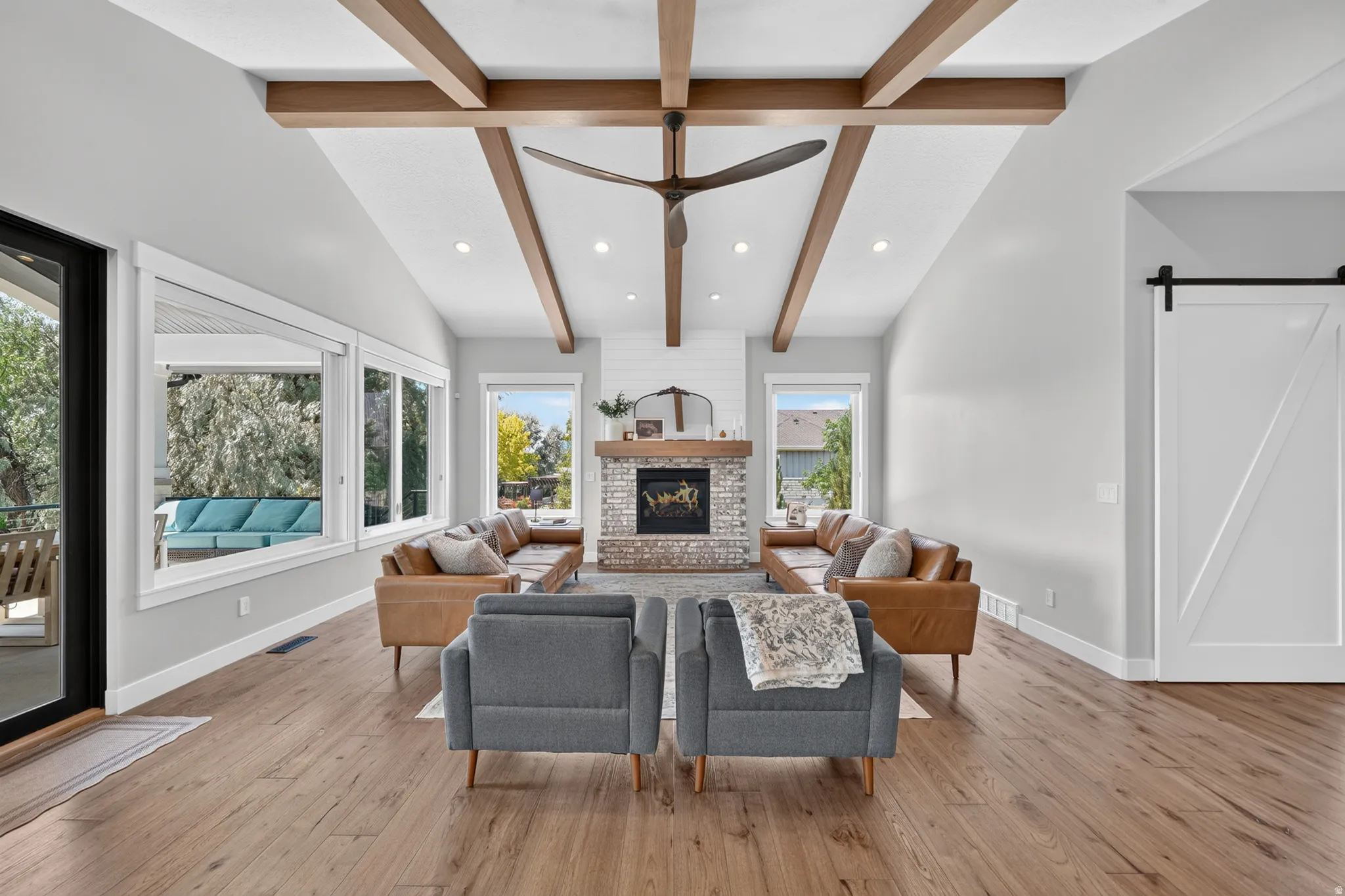 Vaulted ceiling featuring exposed wood beams and recessed lighting