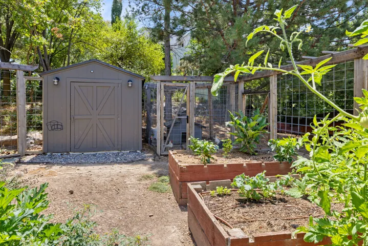 Exterior storage shed with double doors and mounted lighting fixtures.