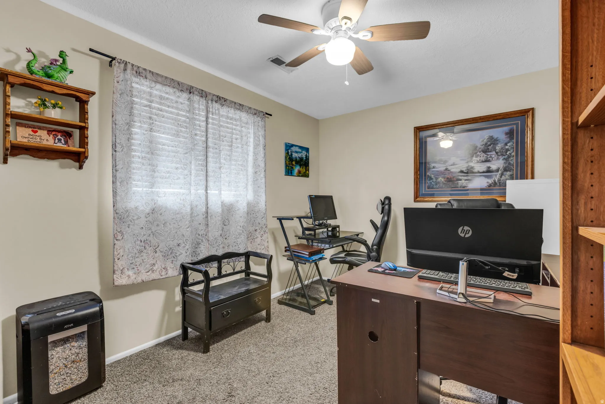 Room with light neutral wall paint and textured carpeting