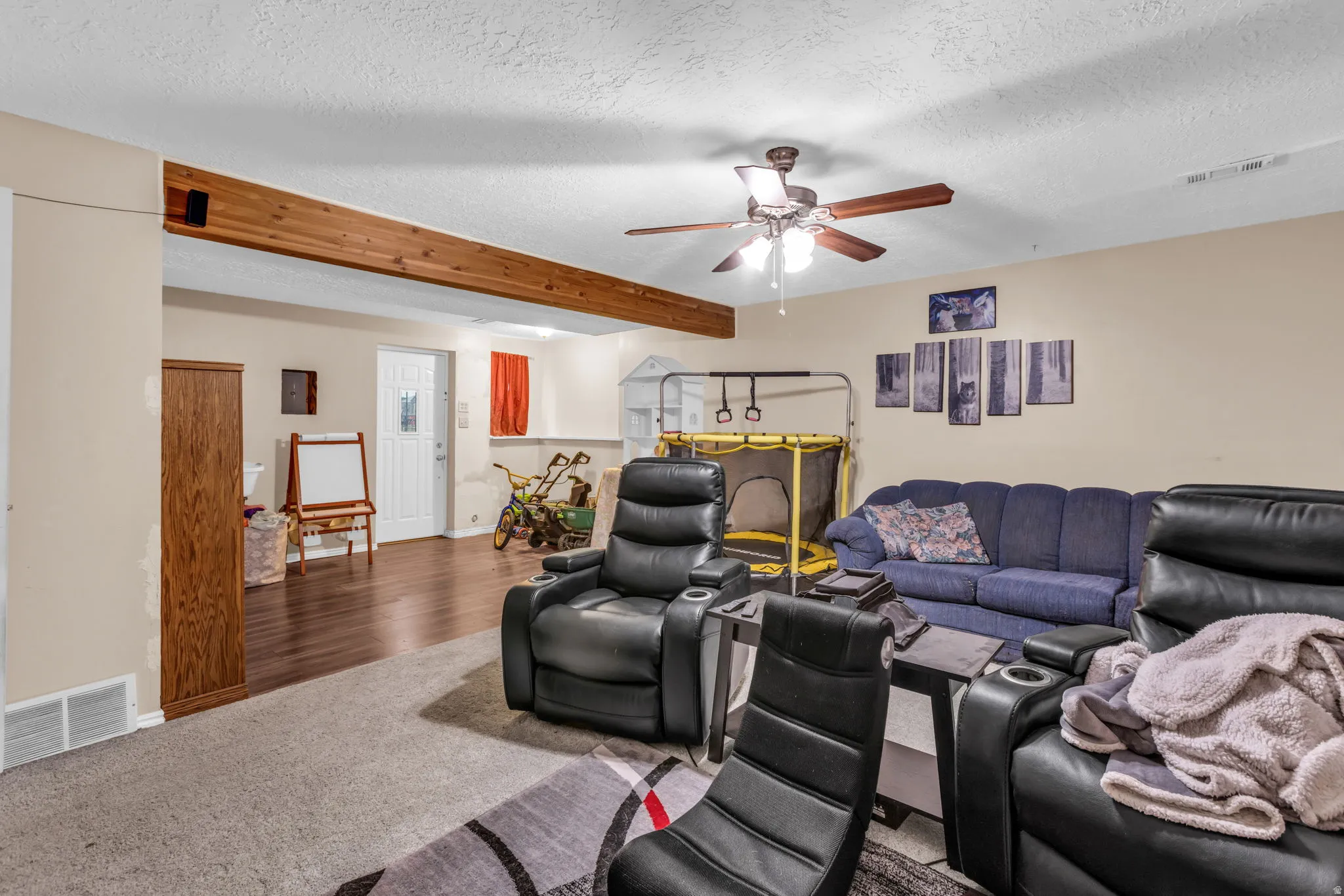 Spacious entertainment area with recessed lighting and a ceiling fan