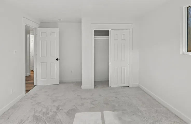 Room featuring light gray carpeting, white walls, and white baseboards