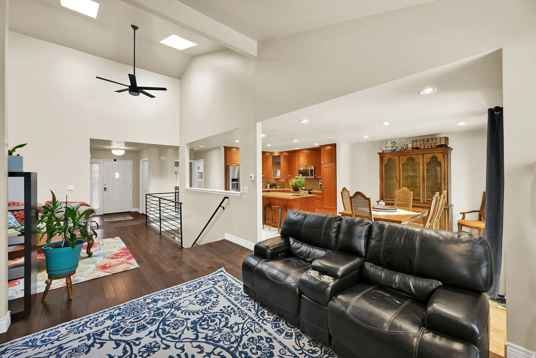 Vaulted ceilings featuring recessed lighting and skylights create an open ambiance