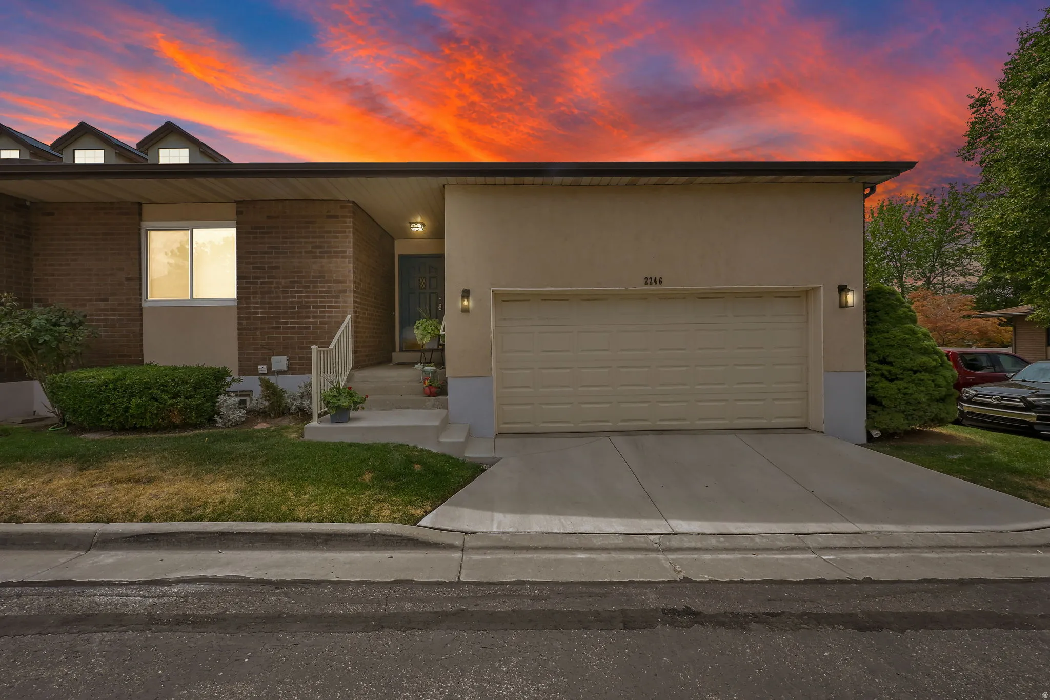 Brick and stucco exterior with an integrated garage