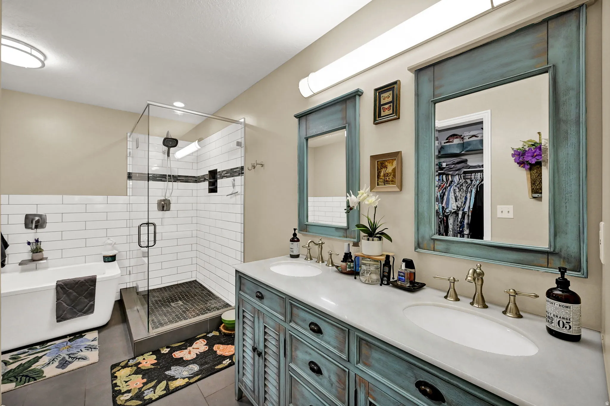 Dual vanity with distressed teal cabinetry and integrated sinks