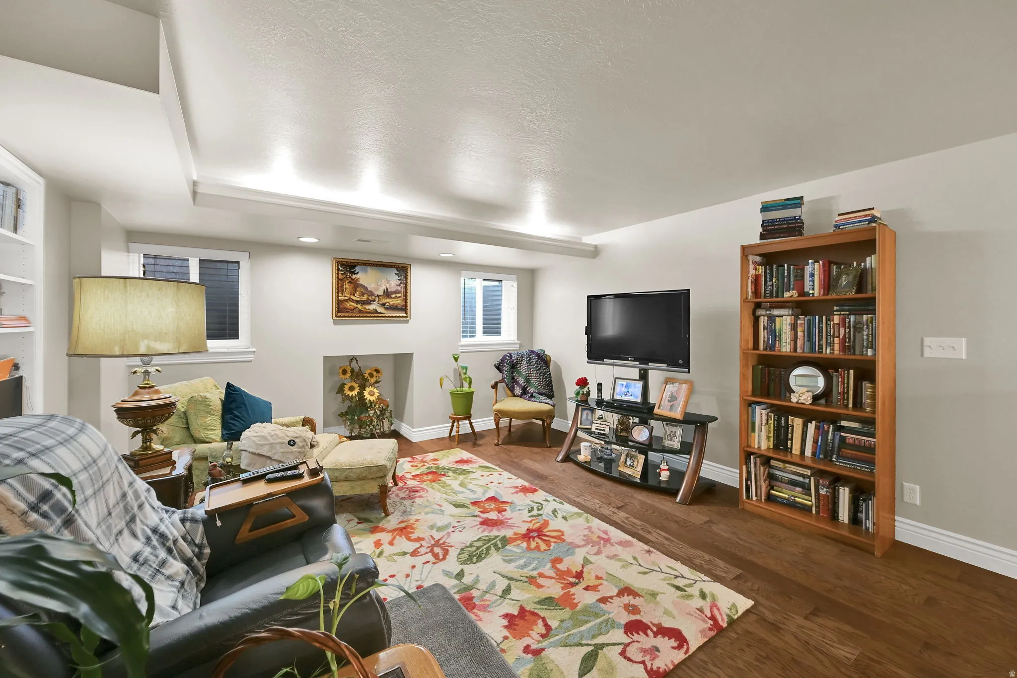 Spacious interior room featuring wood-finish flooring and light gray painted walls
