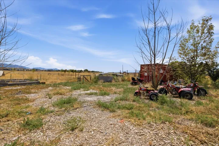 Expansive undeveloped lot featuring a natural landscape and distant mountain ranges
