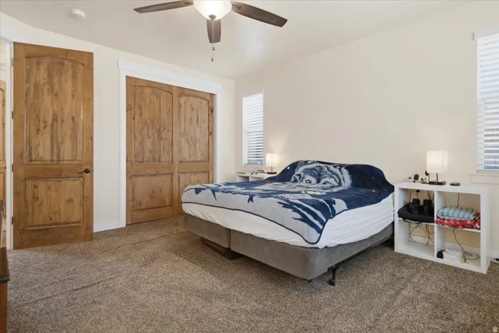Bedroom featuring light-toned wall paint and textured carpeting
