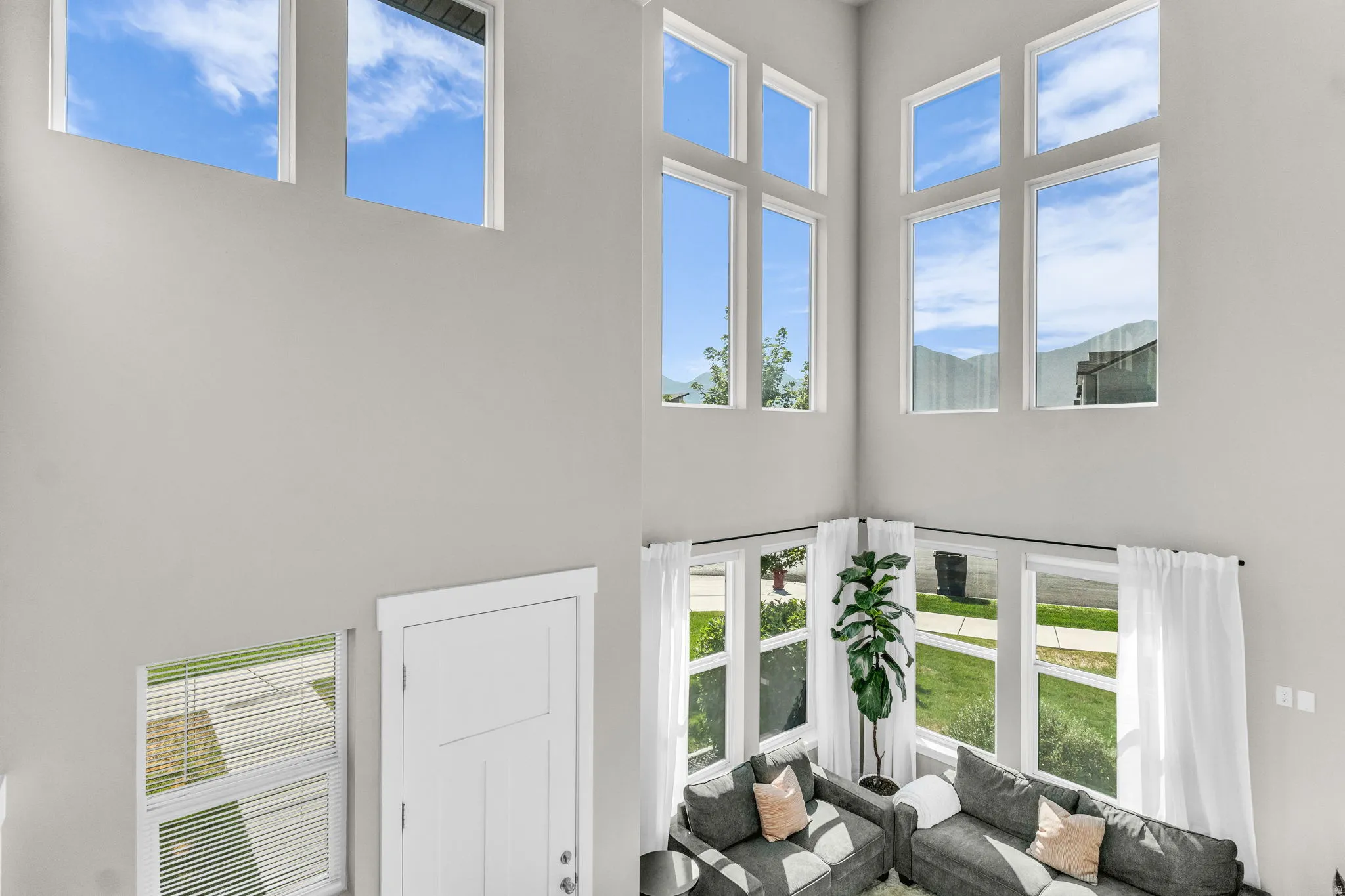 Soaring ceilings complemented by multiple large windows, including transom windows, create an airy atmosphere