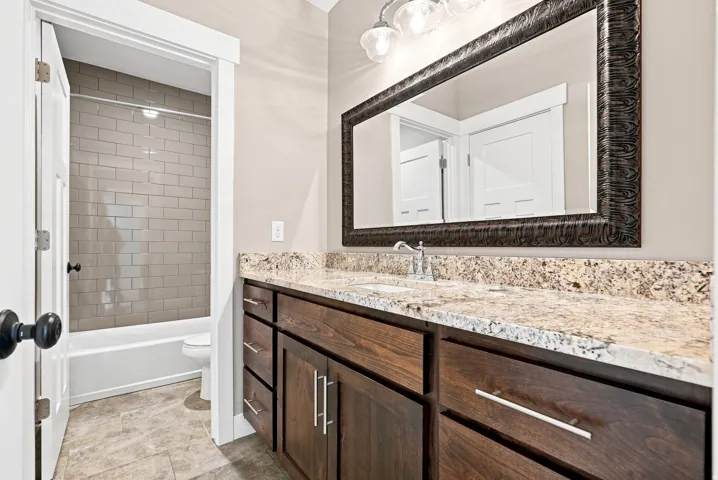 Bathroom vanity with a granite countertop and an undermount sink