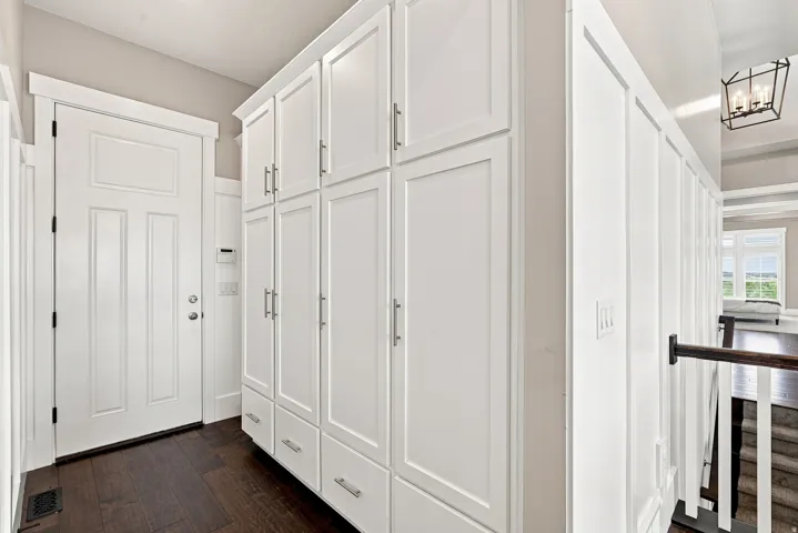 Expansive built-in white cabinetry with brushed nickel hardware