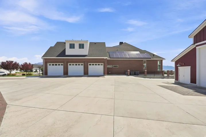 Expansive concrete driveway with brick accents