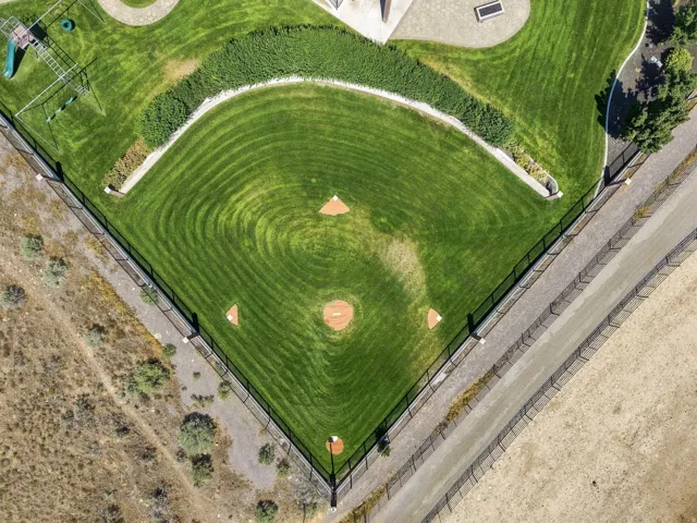 Professionally maintained baseball field featuring a manicured outfield, defined base paths, and a pitcher's mound