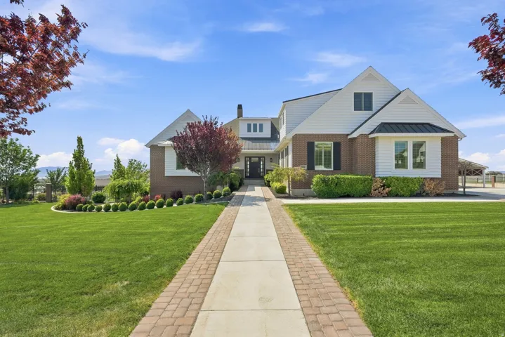 Brick and white siding exterior featuring multiple gables and a bay window