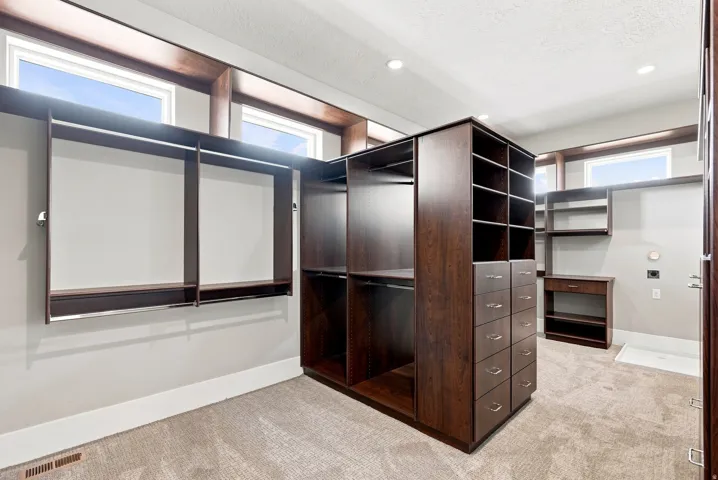 Custom closet system featuring dark wood-finish cabinetry