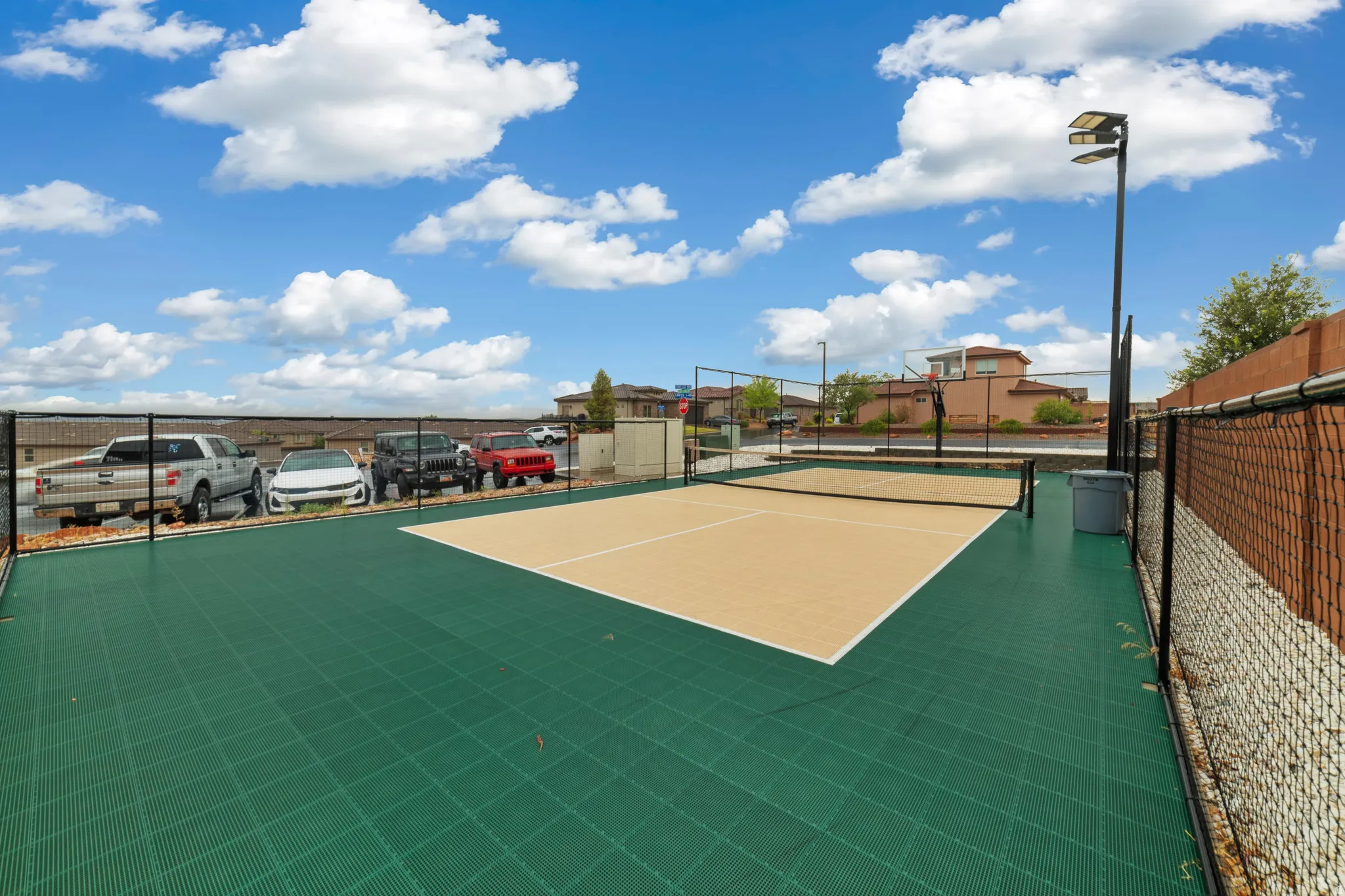 Dedicated pickleball court with a durable modular surface and perimeter fencing