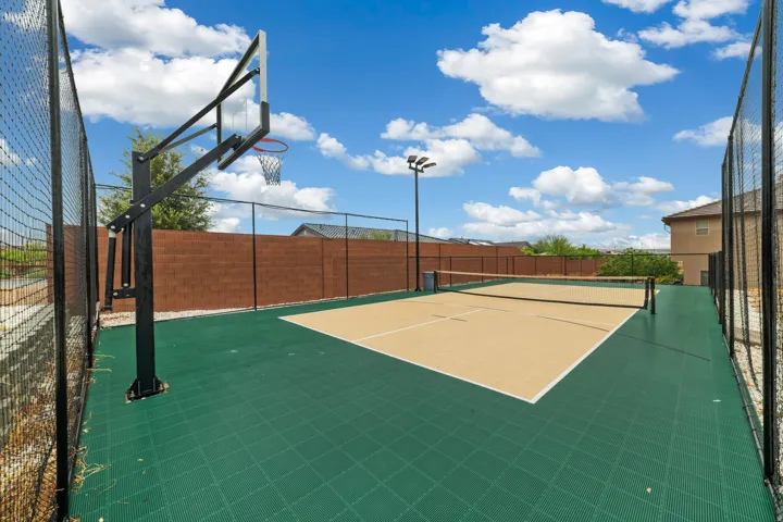Multi-sport court featuring a basketball hoop and pickleball court with a net