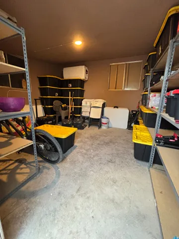 Spacious utility room featuring concrete flooring and a ceiling-mounted light fixture