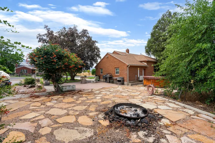 Expansive flagstone patio with a built-in fire pit