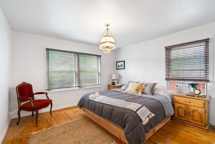 Bedroom featuring wood-finish flooring and white walls