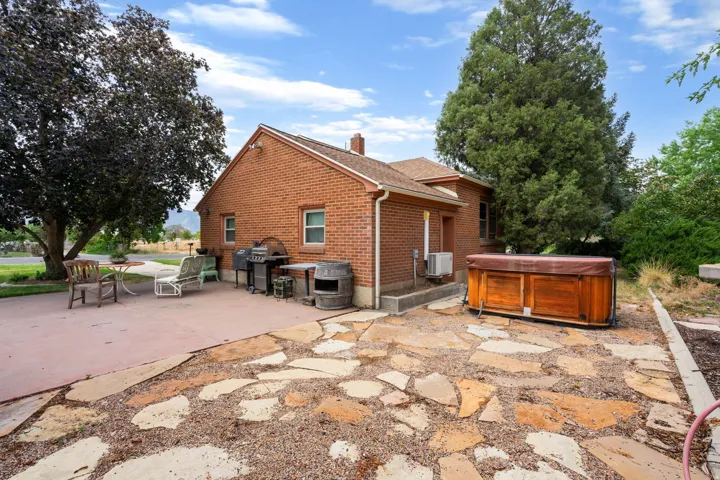 Red brick exterior with white trim windows and a prominent chimney