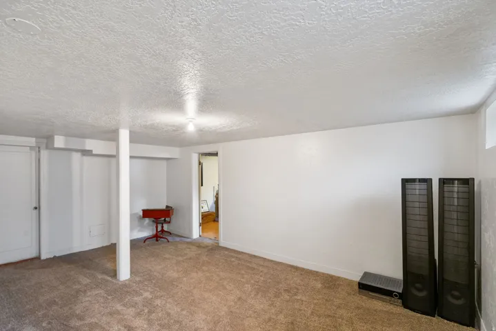 Carpeted room with white painted walls and ceiling