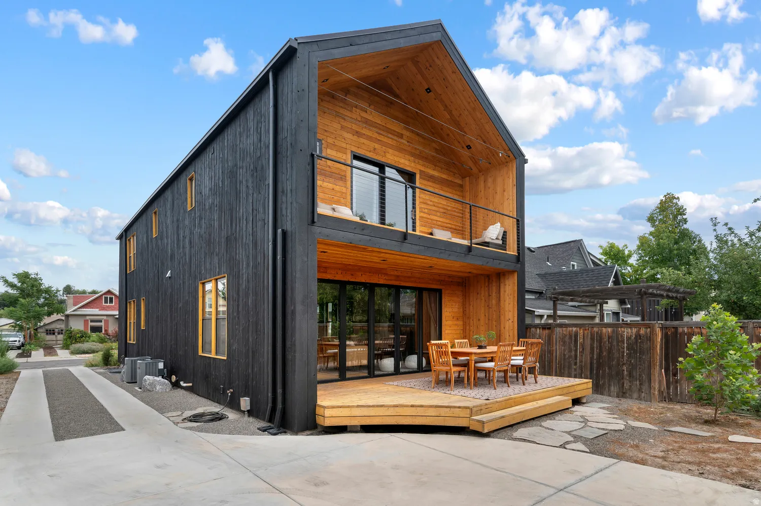Modern architectural design featuring a contrasting black and natural wood exterior