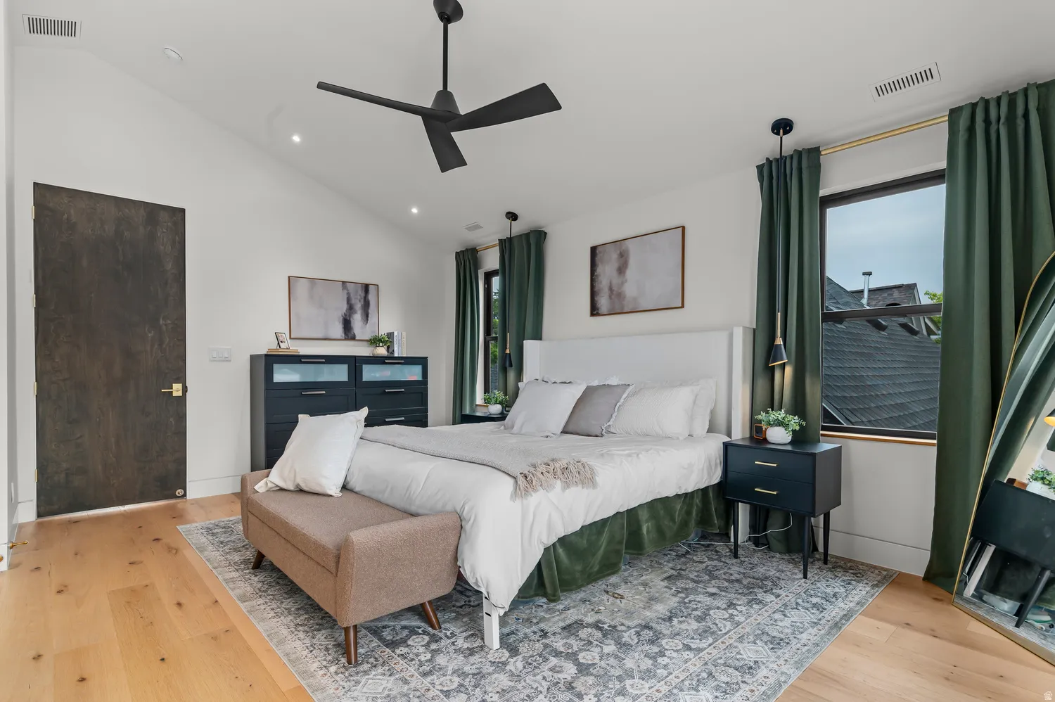 Vaulted ceiling with a black ceiling fan, recessed lighting, and light wood-finish flooring