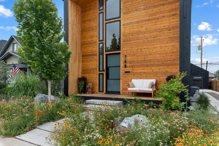 Modern facade featuring natural wood siding and black trim accents