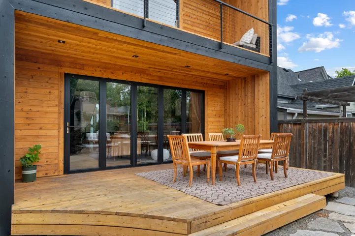 Expansive wood deck with curved steps and natural wood siding