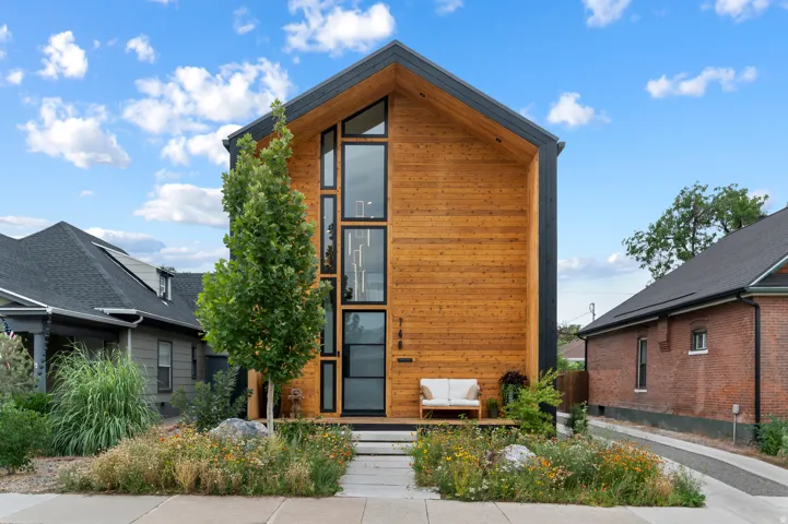 Contemporary exterior featuring natural wood siding and black trim