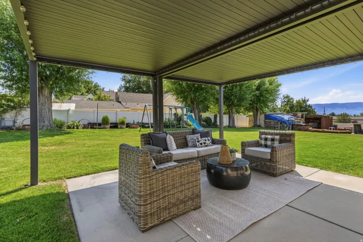 Pergola located just outside the home one of the many outdoor seating areas has sunset views down to Utah Lake.
