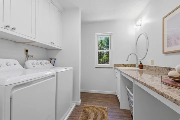 Main level, laundry with half bath and large countertop.