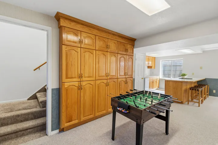 Lower level, game area with built-in storage by kitchenette area.