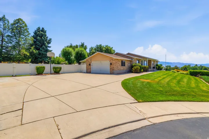 Two car garage and large driveway with plenty of parking.