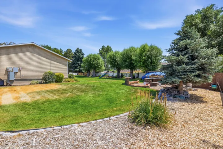 Side of home with fire pit area.