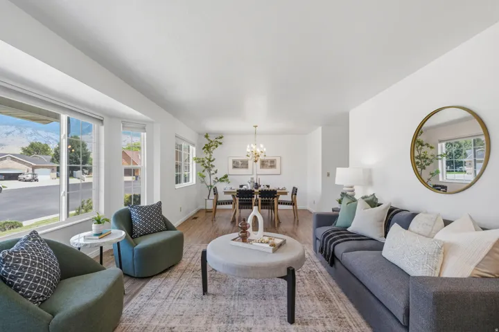 Living room with bay window opens to formal dining room both rooms have mountain and valley views.